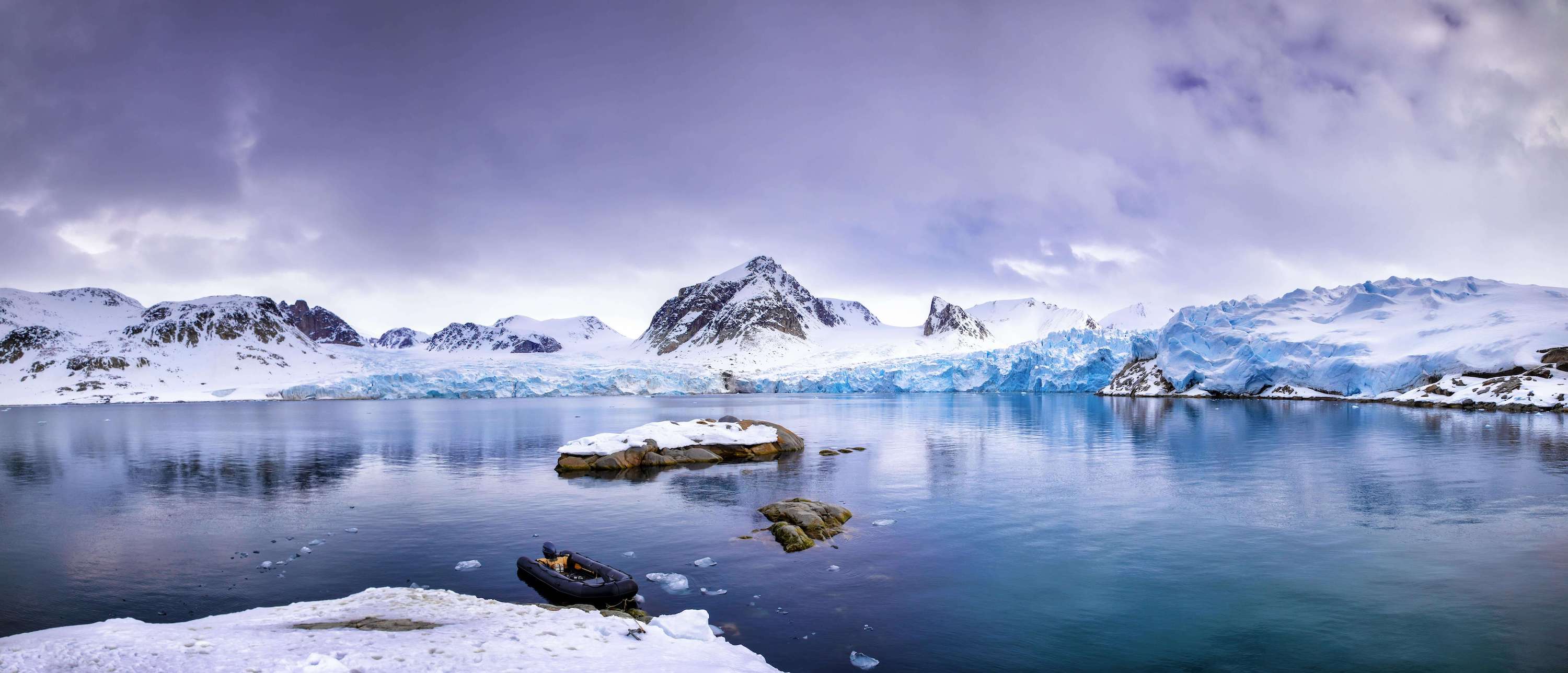 Image of arctic lake in front of snowy mountains
