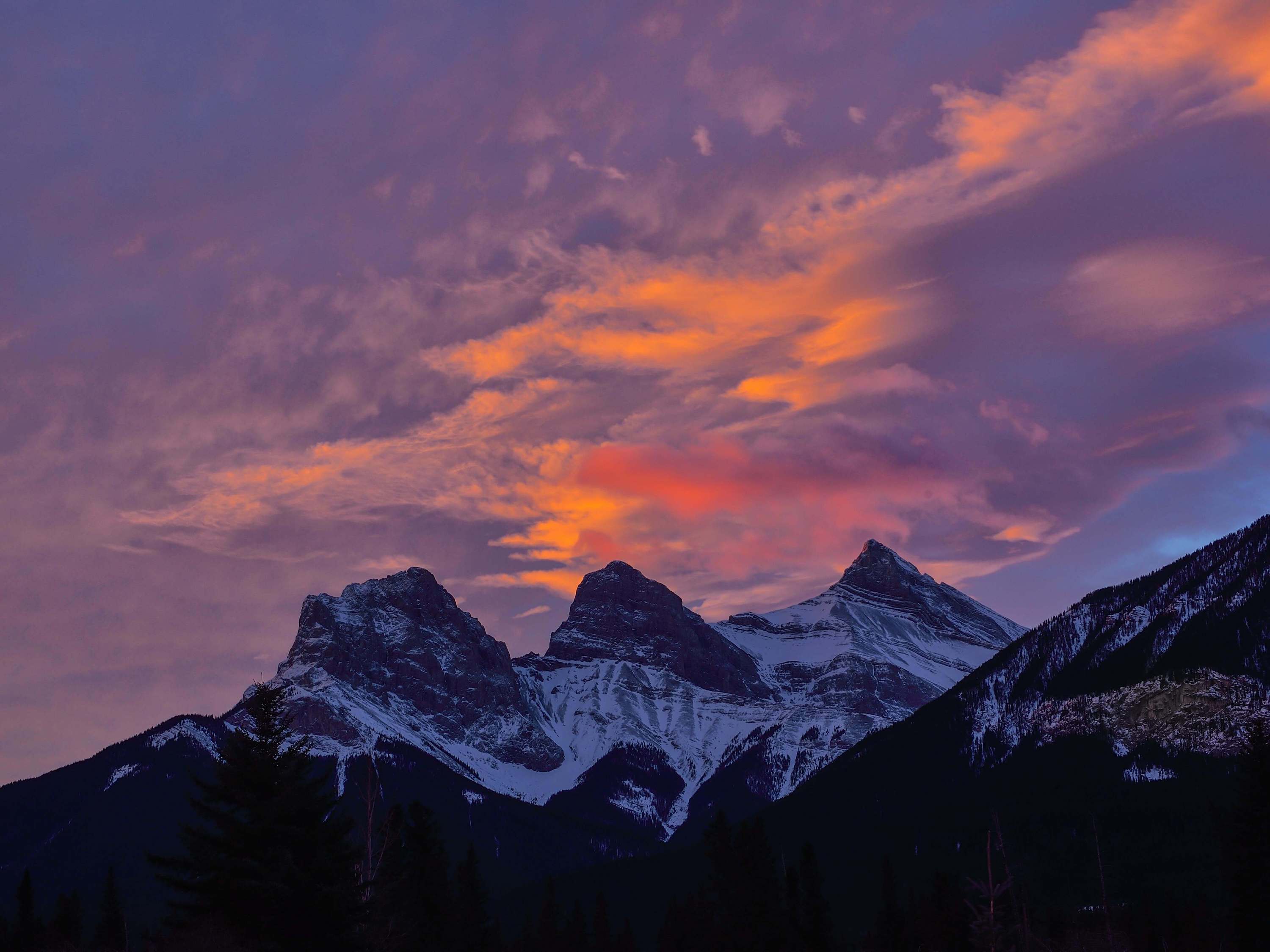 Image of a colourful sky behind a mountain range