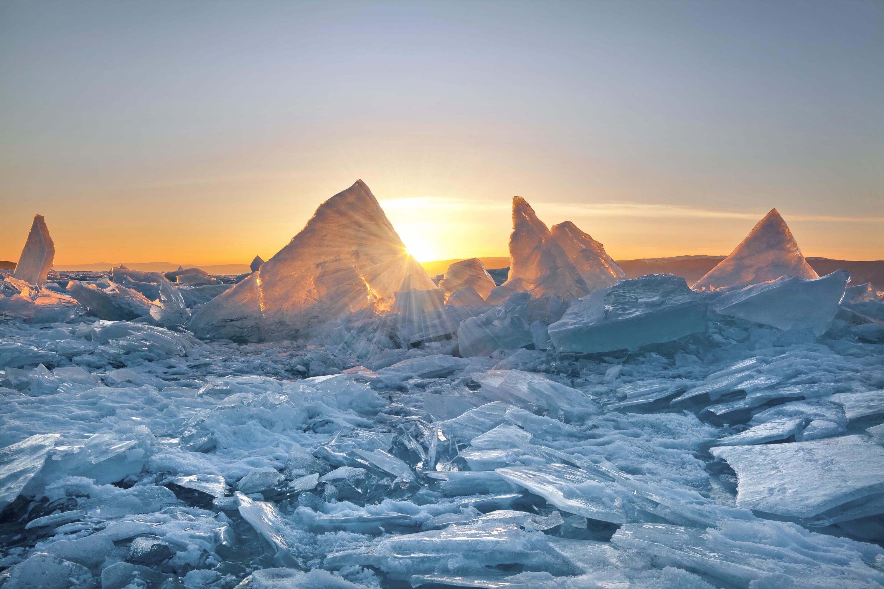 Image of the sun shining behind broken ice